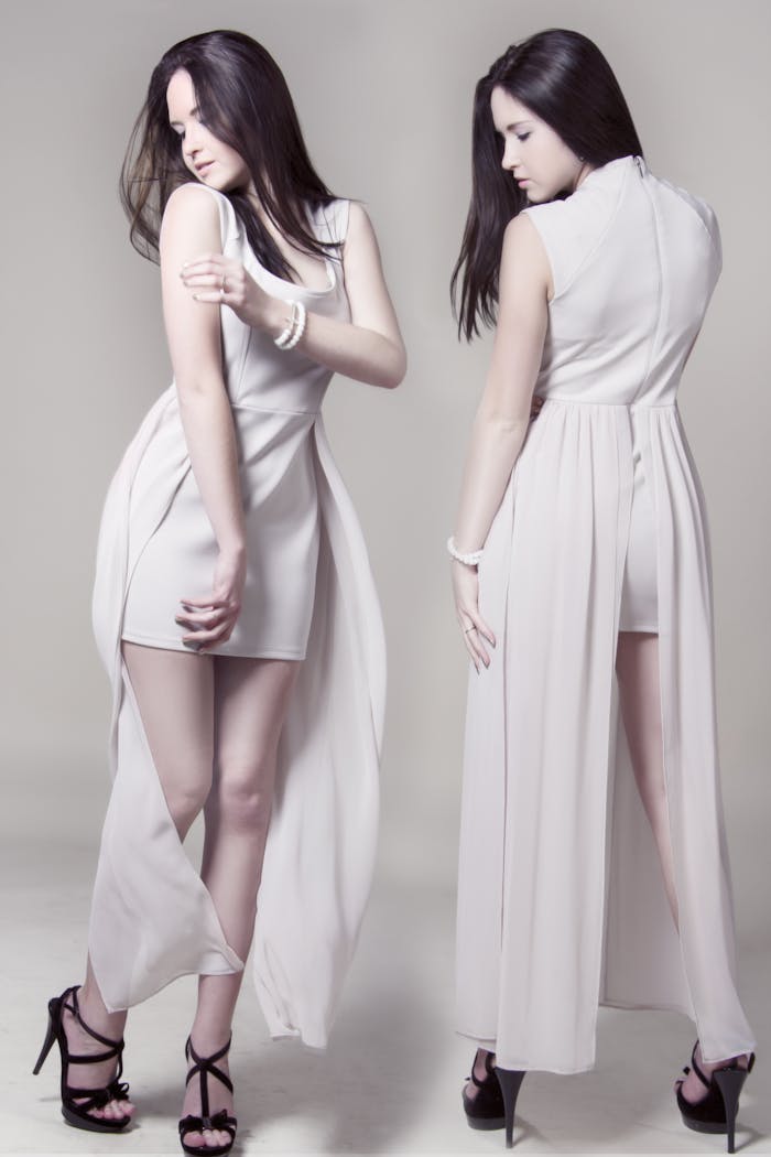 Chic photoshoot featuring two women in white dresses showcasing elegance and style.